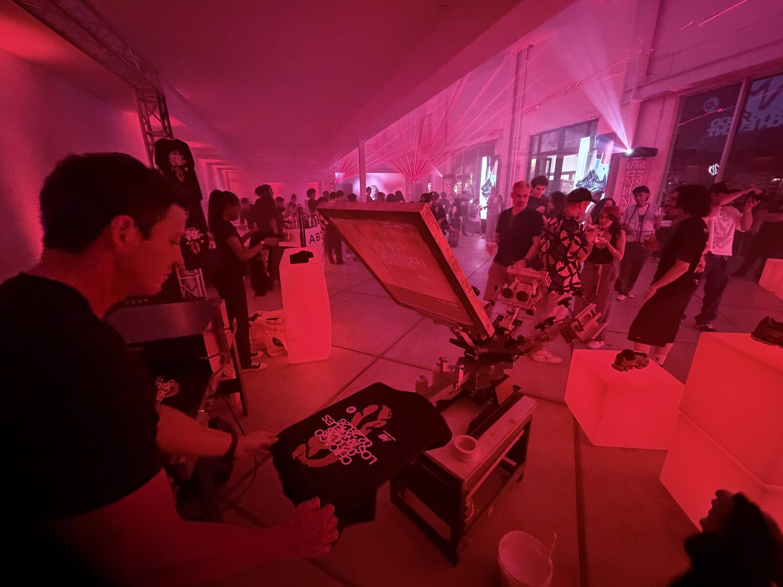 Guest holding up a freshly printed custom t-shirt at a live event t-shirt bar