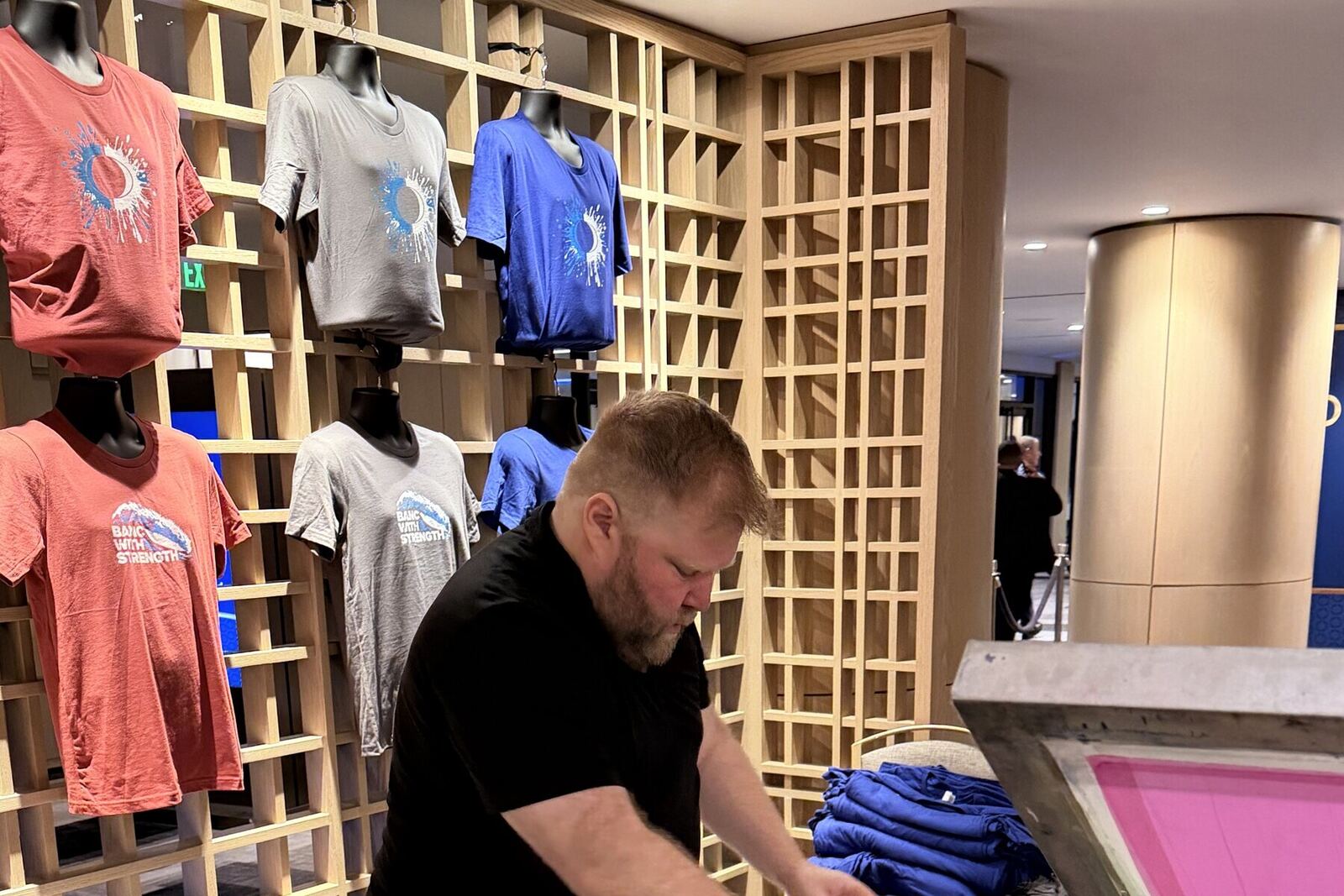 Display of finished printed shirts at the event bar
